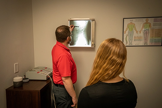Chiropractor Charlotte NC Tyler Maxey Pointing To XRay